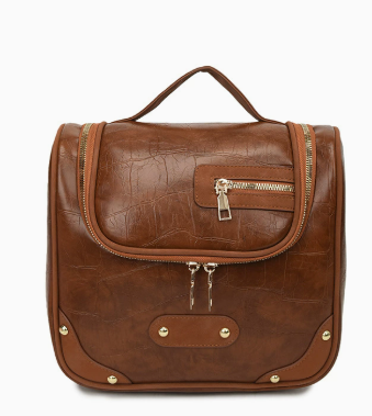 Brown cognac leather travel makeup bag front view with gold hardware and zipper
